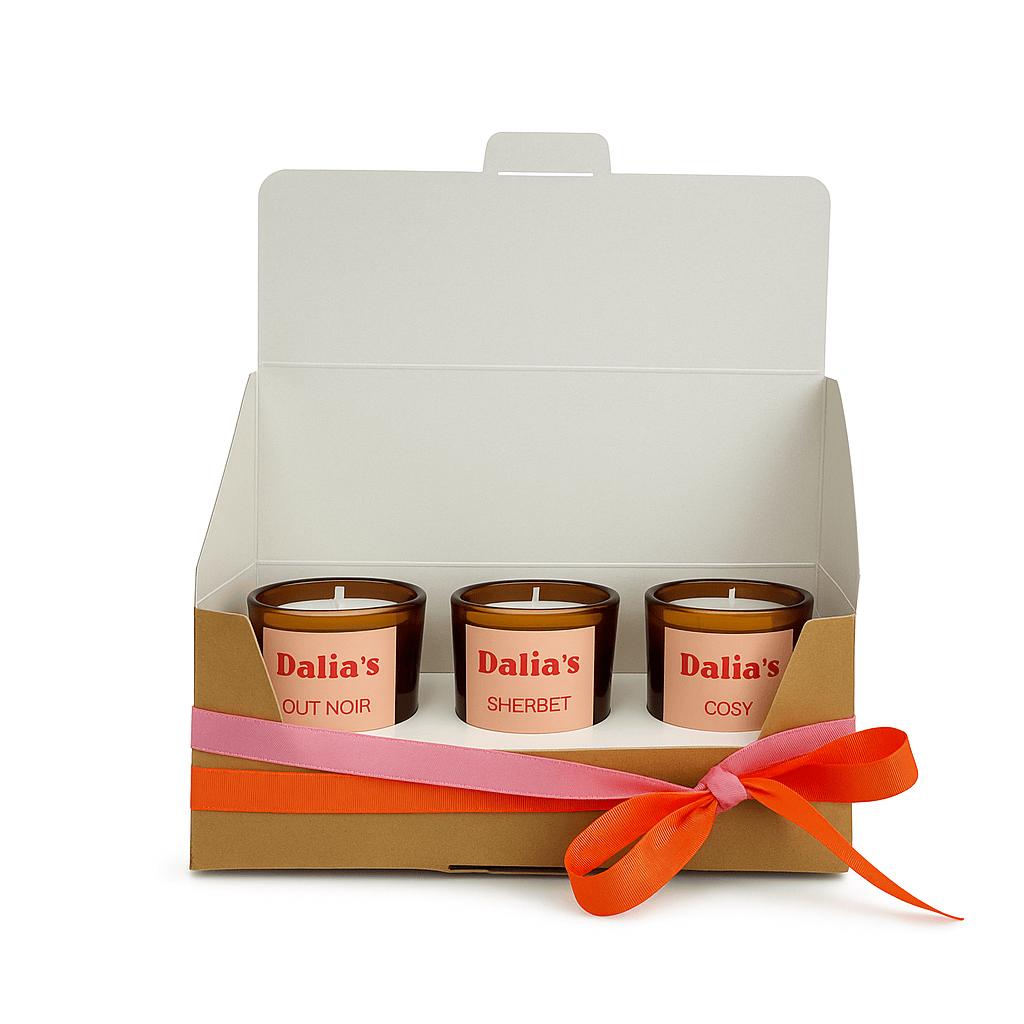 Three Dalia's candles in a decorative box with a pink ribbon on a white background