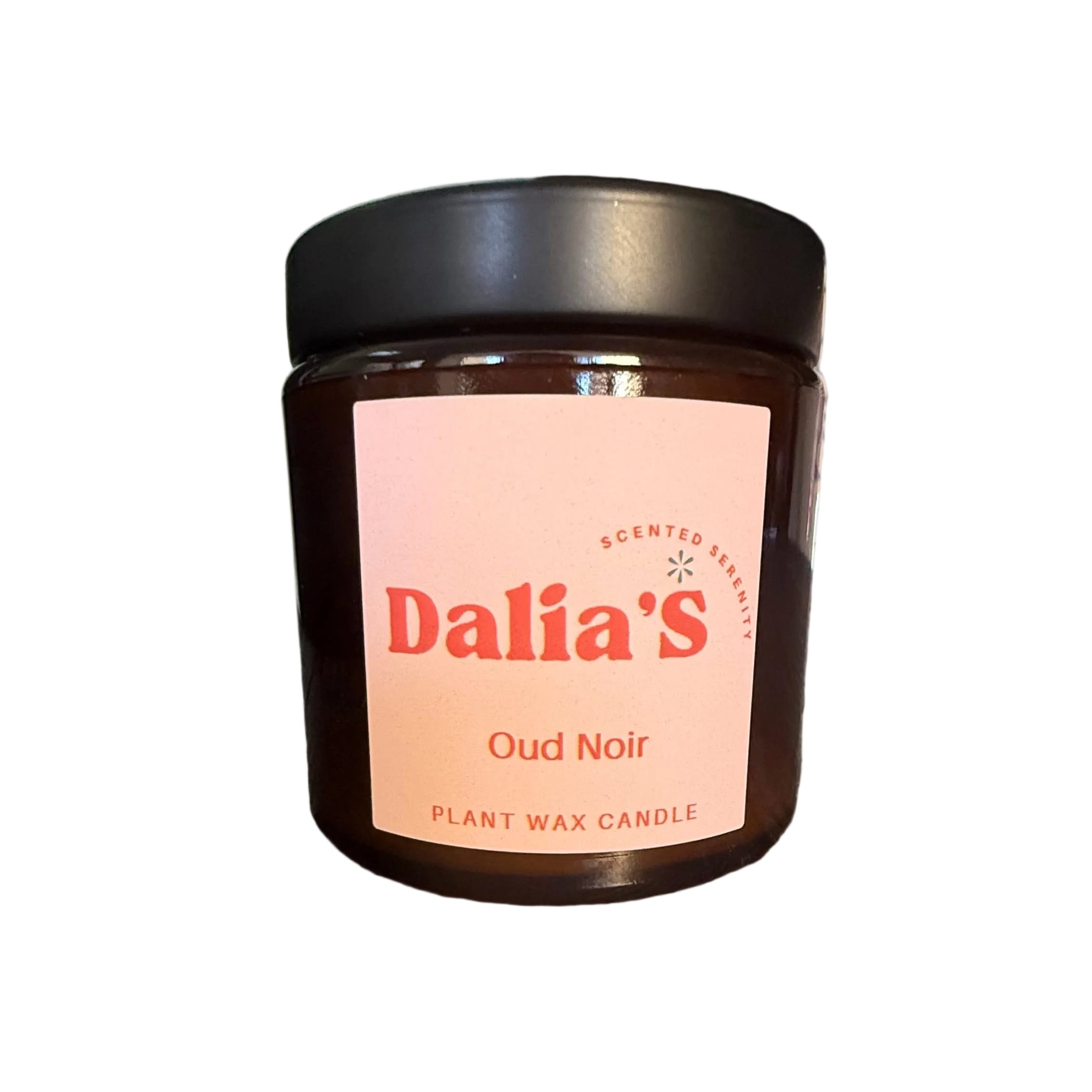 Jar of Dalia's Oud Noir candle on a wooden surface with a neutral background