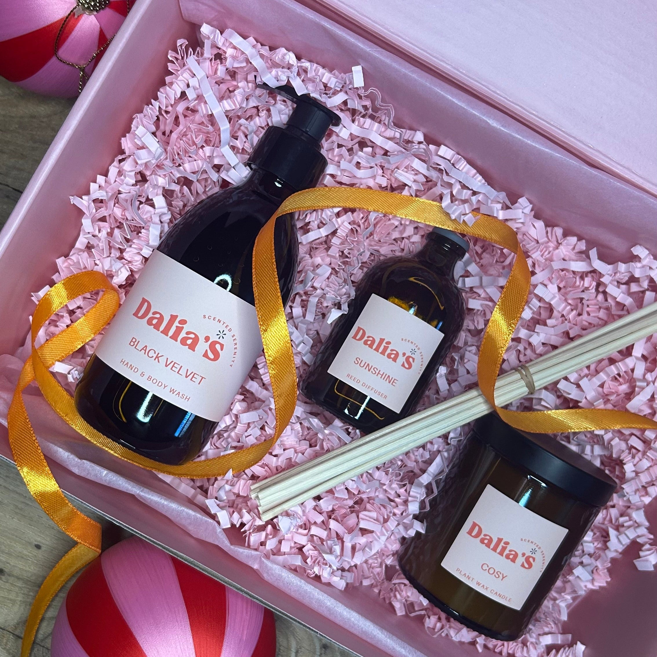 An gift box containing a candle, a reed diffuser, and a hand and body wash bottle, all with 'Dream' in their names, suggesting a theme of relaxation and tranquility.